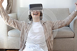 Man wearing virtual reality glasses is playing a 3D game with excitement