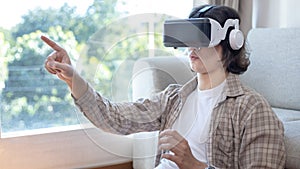 Man wearing virtual reality glasses is playing a 3D game with excitement