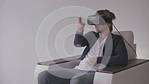 Man Wearing Virtual Reality Glasses Watching Movies or Playing Video Games. VR Headset technology concept.