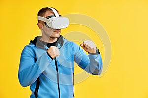 Man wearing virtual reality goggles doing shadow boxing