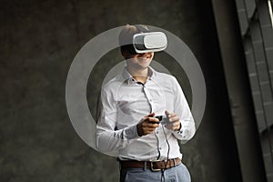 Man wearing virtual reality goggles watching movies or playing video games. The vr headset design is generic and no logos