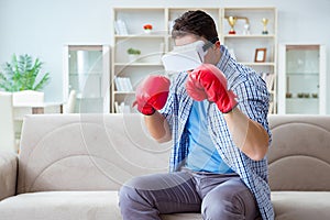 The man wearing virtual reality vr glasses playing boxing game