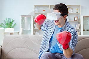 The man wearing virtual reality vr glasses playing boxing game