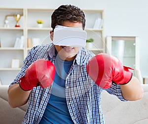 Man wearing virtual reality VR glasses playing boxing game