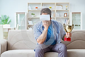 The man wearing virtual reality vr glasses receiving prize cup award