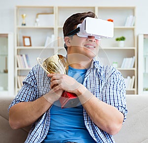 Man wearing virtual reality VR glasses receiving prize cup award