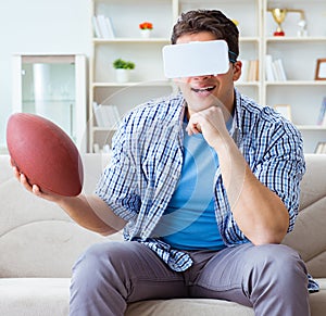 Man wearing virtual reality VR glasses watching american footbal