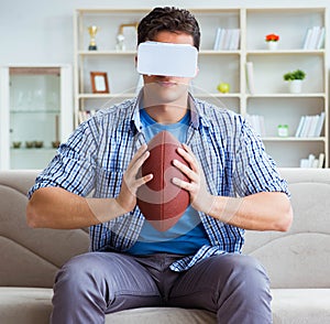 Man wearing virtual reality VR glasses watching american footbal