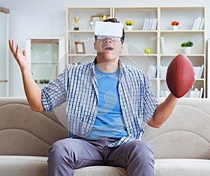 Man wearing virtual reality VR glasses watching american footbal