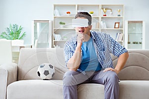 The man wearing virtual reality vr glasses watching soccer football