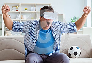 Man wearing virtual reality VR glasses watching soccer football