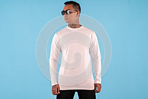 Man wearing white long sleeve t shirt isolated on background.