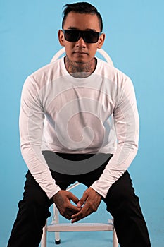 Man wearing white long sleeve t shirt isolated on background.