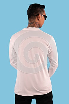 Man wearing white t shirt in back side view isolated on background. Hipster man with tattoo wearing white long sleeve t shirt,