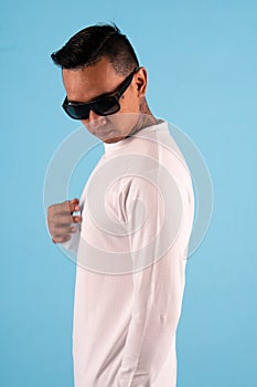 Man wearing white t shirt isolated on white background. Young hipster man wearing t shirt and sunglasses in left side view, ready