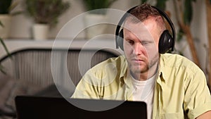 Man wearing wireless headphones watch webinar, trainning