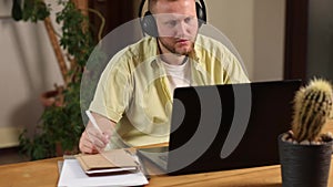 Man wearing wireless headphones watch webinar, trainning