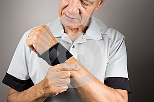 Man wearing a wrist brace or wrap on his left hand and wrist