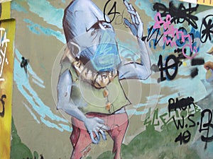 Man wears a mask, Graffiti street art
