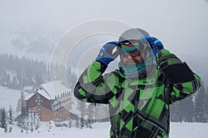 A man wears a ski mask. recreation skier in the mountains