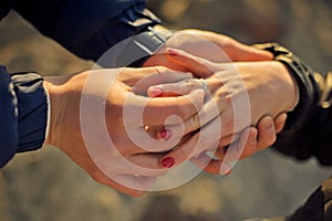 Man wears a wedding ring on woman's hand