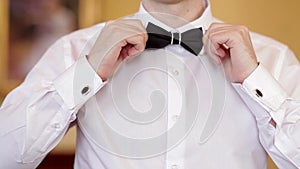 Man wears white shirt and bow tie