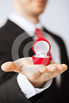 Man with wedding ring and gift box