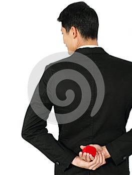 Man with wedding ring and red gift box.