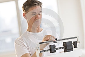 Man Weighing Himself On Balance Weight Scale