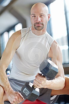 Man, weight lifting and workout in gym for strength with dumbbell, fitness challenge and strong muscle. Bodybuilder, pro