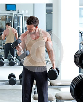 Man with weight training equipment on sport gym photo