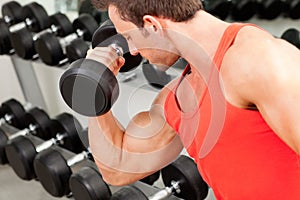 Man with weight training equipment on sport gym