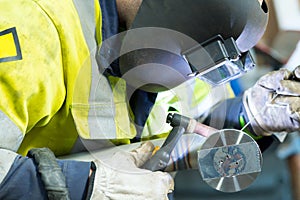 man in welders mask at work