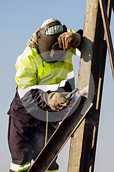 Man welding metal on a construction site, Tradesman working with