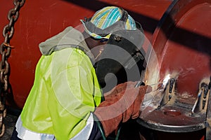 Man welding metal on a construction site, Tradesman working with