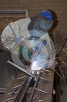 Man welding on production line