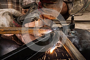 Man welding steel structure close up
