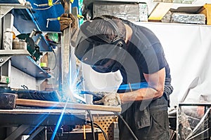 Man welds with a welding machine metal