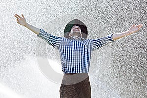 Man wet under rain farmer hat enjoy prayer happy upset heavy wet water shower sun summer pray