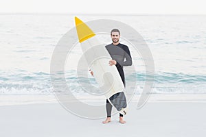 Man in wetsuit with a surfboard on a sunny day