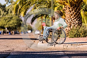 Man in Wheelchair Approaching High City Curb