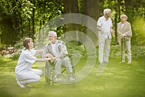 Man on the wheelchair in the garden of professional nursing home