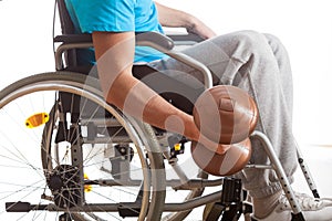 Man in wheelchair lifting weight