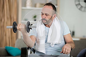 man in wheelchair lifting weights