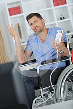 Man in wheelchair making nonchalant gesture