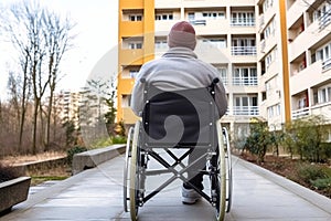 Man in Wheelchair Observing Through Window