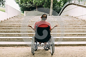 Man in wheelchair outraged in front of stairs