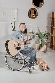 Man on wheelchair playing guitar