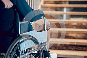 Man in wheelchair stopped near stairs photo
