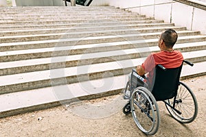 Man in wheelchair stopped because of staircase